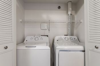 A laundry closet with a washer and dryer.
